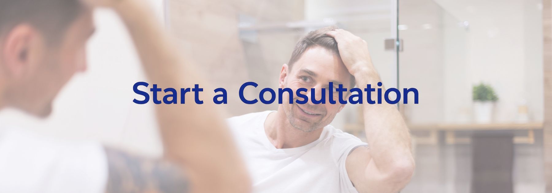 man looking in the mirror at his hair